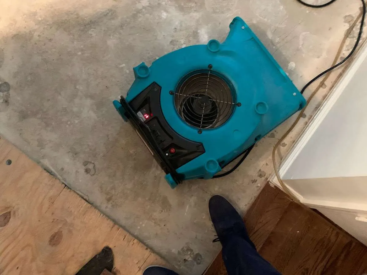 Air mover drying subfloor during Leak Detection & Repair in El Campo
